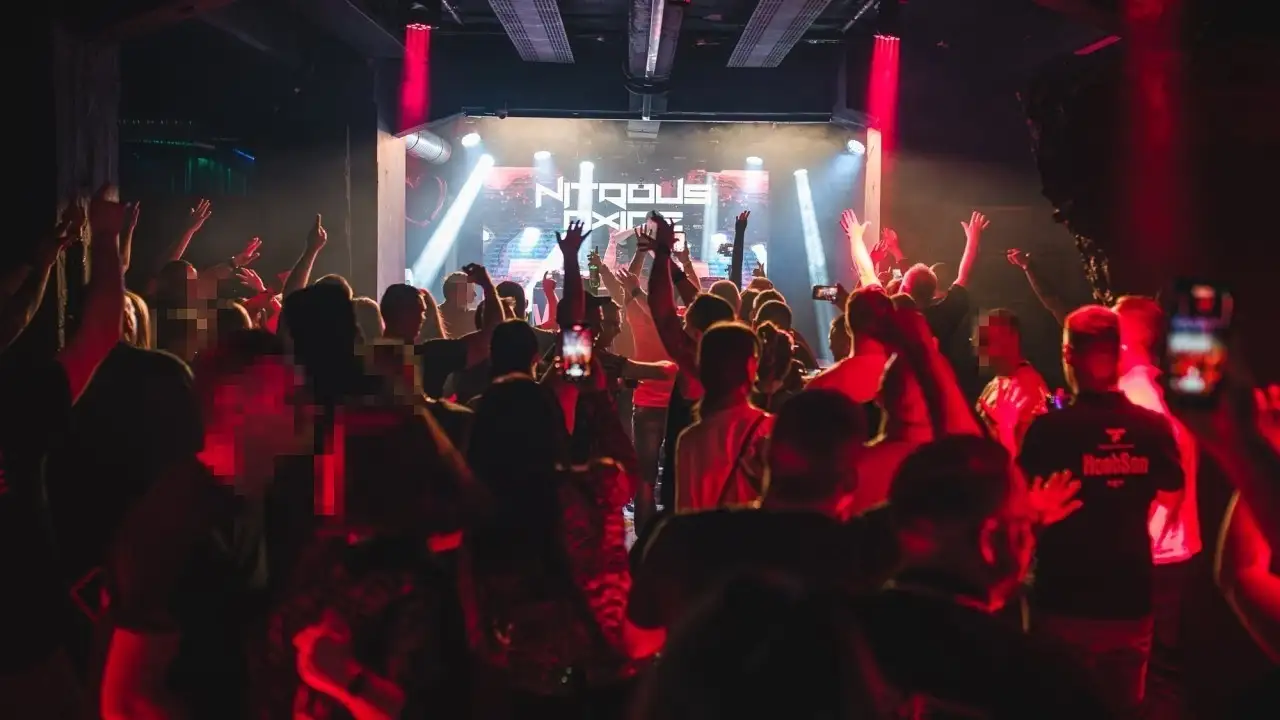 A crowded dance floor in front of the stage at the HAH club. Image owned by HAH and available here: https://www.facebook.com/photo/?fbid=1386546106840012&set=a.1386554190172537