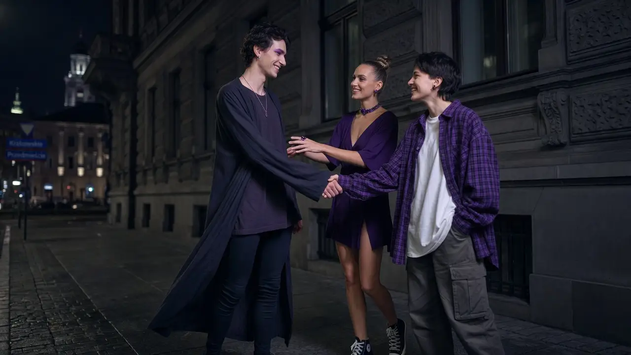 A group of queer people greeting each other in front of a tenement house on a Warsaw street
